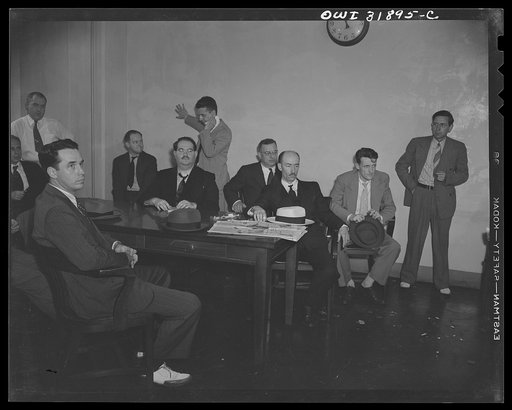 Untitled photo, possibly related to: Witnesses(?) in a "black market" case. A reconstruction photographed during the filming of "Black Marketing," a motion picture produced by the U.S. Office of War Information (OWI) and released August 19, 1943
