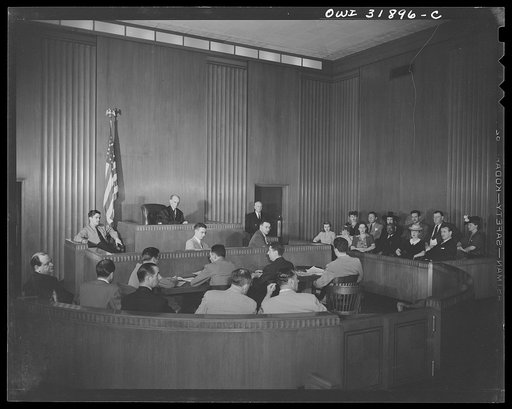 A courtroom scene during a case on illegal meat sales or "black marketing." A reconstruction photographed during the filming of "Black Marketing," a motion picture produced by the U.S. Office of War Information (OWI)