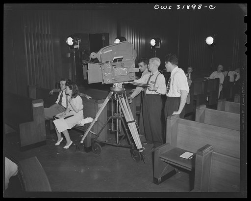 The camera and crew engaged in the filming of "Black Marketing," a motion picture produced by the U.S. Office of War Information (OWI) and released August 19, 1943