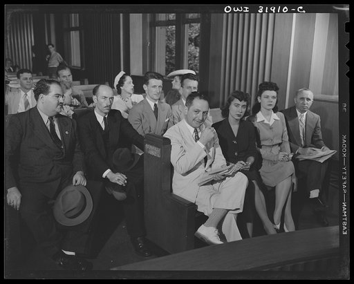 Witnesses(?) in a "black market" case. A reconstruction photographed during the filming of "Black Marketing," a motion picture produced by the U.S. Office of War Information (OWI) and released August 19, 1943