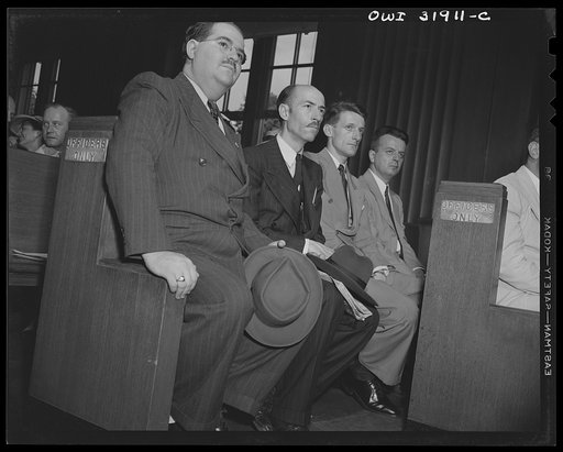 Four actors(?) in "Black Marketing," a motion picture produced by the Office of War Information (OWI) and released August 19, 1943