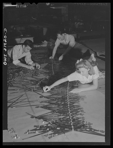 Untitled photo, possibly related to: Washington, D.C. Left to right: Mrs. Marvel Barnekov, engineering aid, Joel Langjofer, chief engineering aid, employees of the U.S. Geological survey, Alaska branch, and Dr. William Wrather, director of the Geological Survey, adjusting templates to a base map man