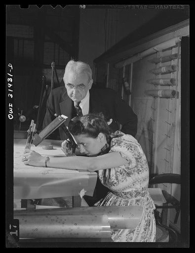 Washington, D.C. Dr. Philip S. Smith, chief Alaskan geologist, and Miss Hallman, engineering aid, employees of the U.S. Geological survey, Alaska branch, using an oblique sketch master. The instrument transfers the planimetry from the oblique photgraph to the base manuscript used on air navigation c