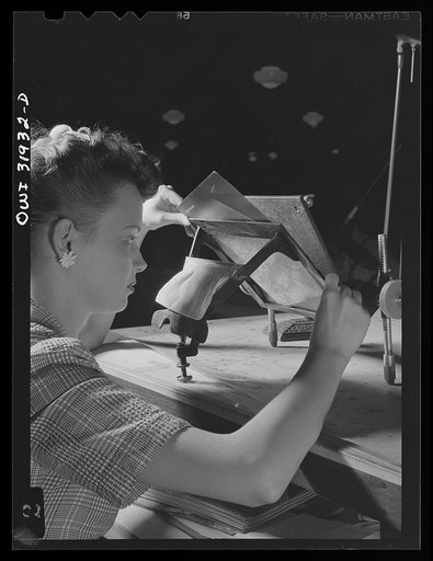 Untitled photo, possibly related to: Washington, D.C. Miss Alice Blackwell, an employee of the U.S. Geological Survey, Alaska branch, is inserting an oblique aerial photograph into the oblique sketch master for the purpose of transferring the planimetry from the photograph to the base map of the man