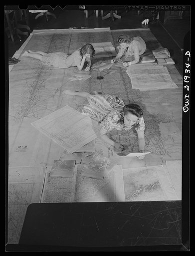 Untitled photo, possibly related to: Washington, D.C. Miss Barbara Austin, Mrs. Mary Keddy, and Miss Martha Hallman, three employees of the U.S. Geological Survey, Alaska branch, making a final checking of the base manuscript, in connection with air navigation charts