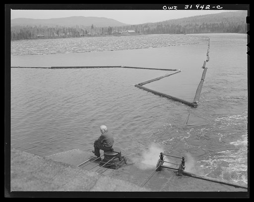 Spring pulpwood drive on the Brown Company timber holdings in Maine. Steamer stretching out the boom surrounding the load of logs it must tow down Mooselookmeguntic Lake