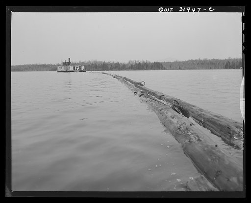 Spring pulpwood drive in Brown Company lumber holdings in Maine. On its return trip up Mooselookmeguntic Lake, the steamer tows an empty boom to be refilled for the next days load