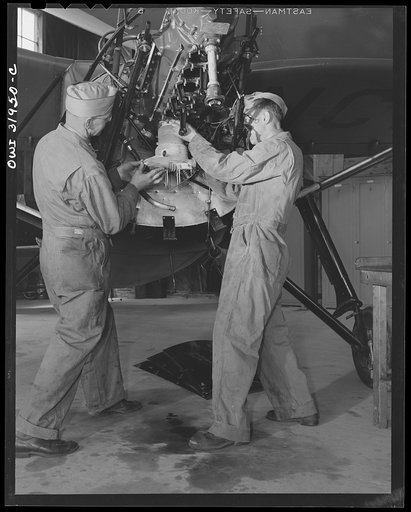 Untitled photo, possibly related to: Bar Harbor, Maine. Ground crew making routine overhaul of a patrol plane