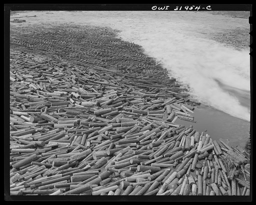 Spring pulpwood drive, Brown Company timber holdings. Pulpwood sluicing through upper dam at the foot of Mooselookmeguntic Lake, Maine