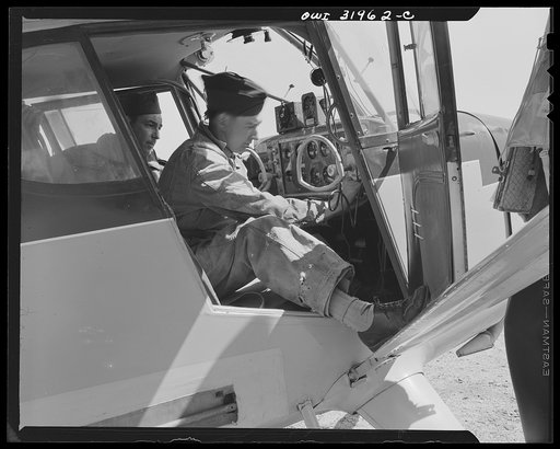 Bar Harbor, Maine. Civil Air Patrol base headquarters of Coastal patrol no. 20. Ground crew mechanic making an adjustment on the radio of a patrol plane