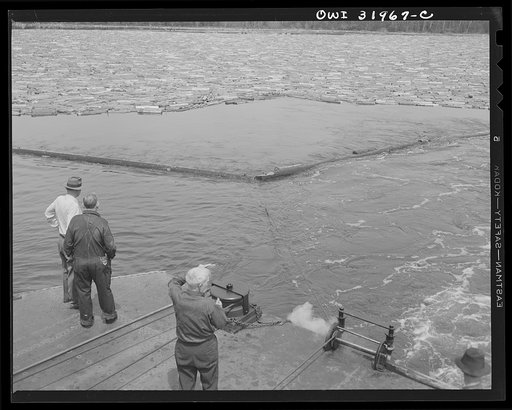 Spring pulpwood drive on the Brown Company timber holdings in Maine. Steamer stretching out the boom surrounding the load of logs it must tow down Mooselookmeguntic Lake
