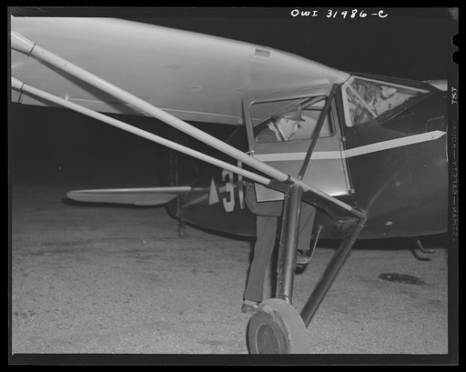 Bar Harbor, Maine. Civil Air Patrol base headquarters of coastal patrol no. 20. Pilot starting on dawn patrol