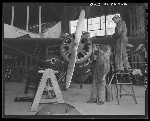 Bar Harbor, Maine. Civil Air Patrol base headquarters of coastal patrol no. 20. Ground crew making a routine overhaul of a patrol plane