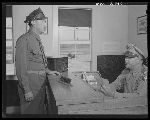 Bar Harbor, Maine. Civil Air Patrol base headquarters of coastal patrol no. 20. Lietenant Day, intelligence officer, receiving orders from the base commander, Major J.B. King