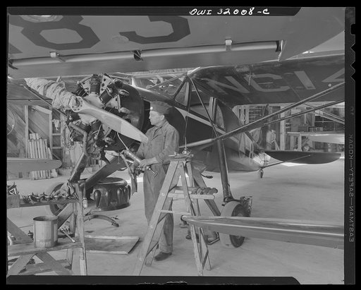 Bar Harbor, Maine. Civil Air Patrol base headquarters of coastal patrol no. 20. Ground crew making a routine overhaul of a patrol plane