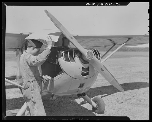 Bar Harbor, Maine. Civil Air Patrol base headquarters of coastal patrol no. 20. Ground crew making a routine overhaul of a patrol plane