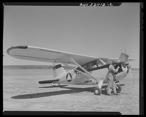 Bar Harbor, Maine. Civil Air Patrol base headquarters of coastal patrol no. 20. Ground crew making a routine overhaul of a patrol plane