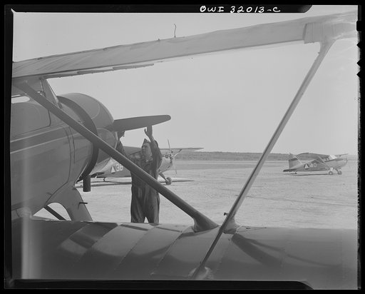Bar Harbor, Maine. Civil Air Patrol base headquarters of coastal patrol no. 20. Ground crew making a routine overhaul of a patrol plane