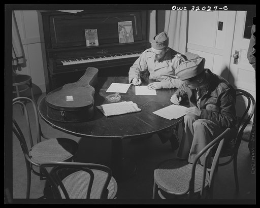 Untitled photo, possibly related to: Bar Harbor, Maine. Civil Air Patrol base headquarters of coastal patrol no. 20. The officer of the day interrupting music to issue flight instructions.