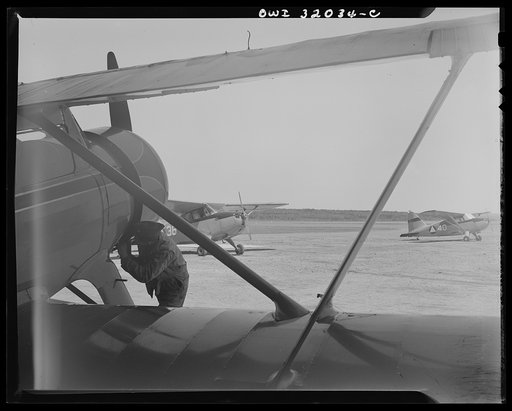 Untitled photo, possibly related to: Bar Harbor, Maine. Civil Air Patrol base headquarters of coastal patrol no. 20. Ground crew making a routine overhaul of a patrol plane