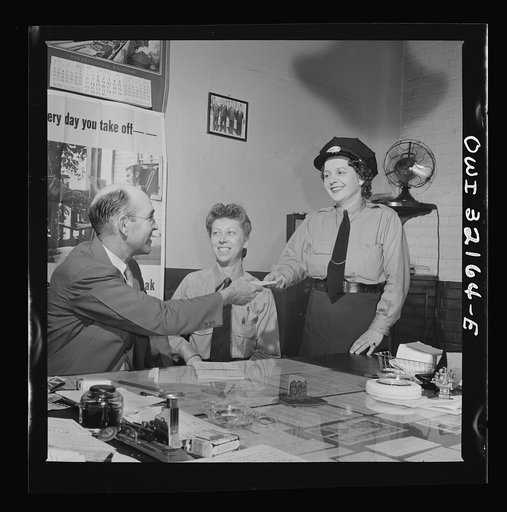 Washington, D.C. Women streetcar and bus operators Hattie B. Sheehan (standing) and Frances Lewis being interviewed by Superintendent Henshaw of the Capitol Transit Company