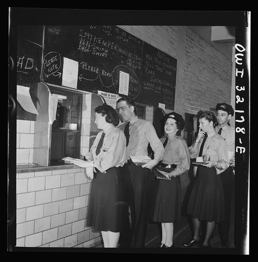 Untitled photo, possibly related to: Washington, D.C. Streetcar and bus operators of the Capitol Transit Company turning in their daily receipts to a receiver at the depot