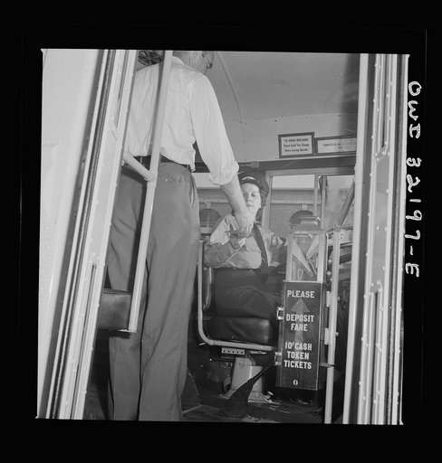 Untitled photo, possibly related to: Washington, D.C. An instructor of the Capitol Transit Company teaching a woman to operate a one-man streetcar