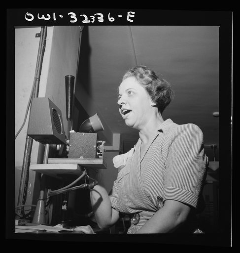 Washington, D.C. Miss Mabel Stargel talks into a microphone of the office intercommunication system at Western Union telegraph office