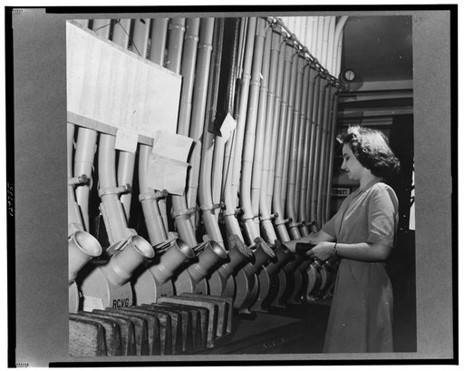 Washington, D.C. Miss Helen Ringwald works with the pneumatic tubes through which messages are sent to branches in other parts of the city for delivery