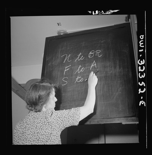 Washington, D.C. Mrs. Susan Poyce writing switching instructions on a blackboard at the Western Union telegraph office