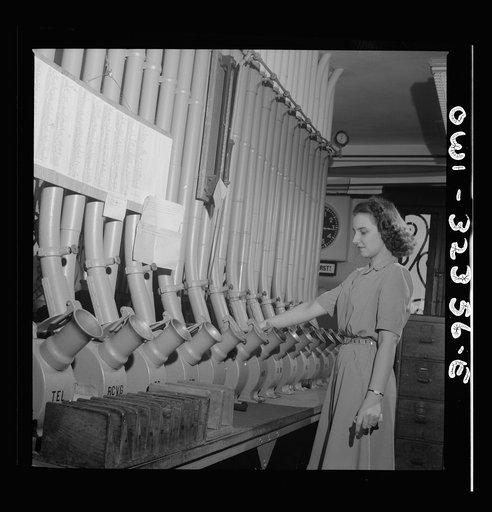 Untitled photo, possibly related to: Washington, D.C. Miss Helen Ringwald works with the pneumatic tubes through which messages are sent to branches in other parts of the city for delivery