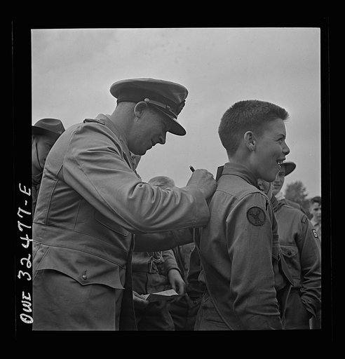Oswego, New York. A Norwegian naval officer writing his autograph for a boy scout during United Nations week