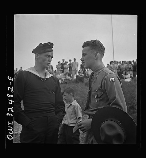 Untitled photo, possibly related to: Oswego, New York. Boy scout giving an insignia to a Norwegian naval officer and sailor on Flag Day during United Nations week