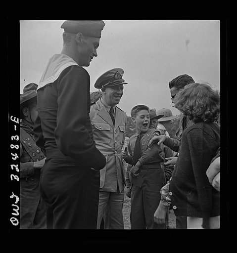 Oswego, New York. Boy scout giving an insignia to a Norwegian naval officer and sailor on Flag Day during United Nations week