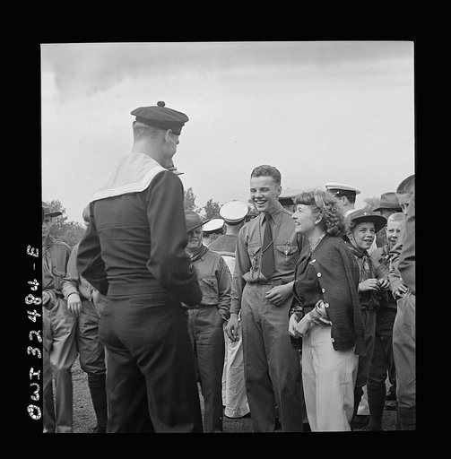 Untitled photo, possibly related to: Oswego, New York. Boy scout giving an insignia to a Norwegian naval officer and sailor on Flag Day during United Nations week