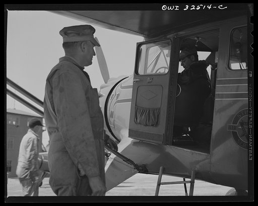 Untitled photo, possibly related to: Bar Harbor, Maine. Civil Air Patrol base headquarters of coastal patrol no. 20. Pilot signing out before taking off for patrol
