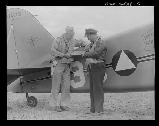 Untitled photo, possibly related to: Bar Harbor, Maine. Civil Air Patrol base headquarters of coastal patrol no. 20. A pilot and an observer before taking off on dusk patrol