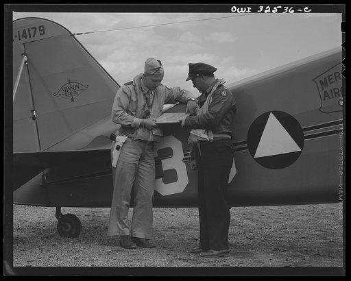 Untitled photo, possibly related to: Bar Harbor, Maine. Civil Air Patrol base headquarters of coastal patrol no. 20. A pilot and an observer before taking off on dusk patrol
