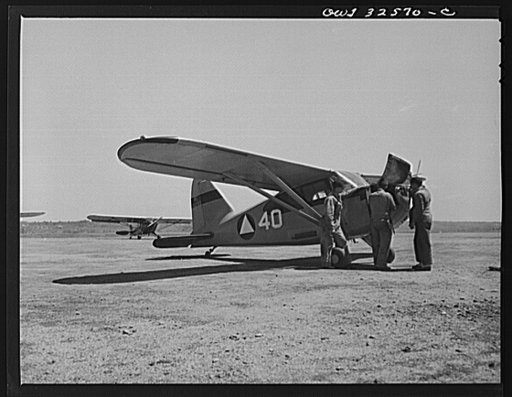 Untitled photo, possibly related to: Bar Harbor, Maine. Civil Air Patrol base headquarters of coastal patrol no. 20. Ground crew tuning up a plane before the dusk patrol