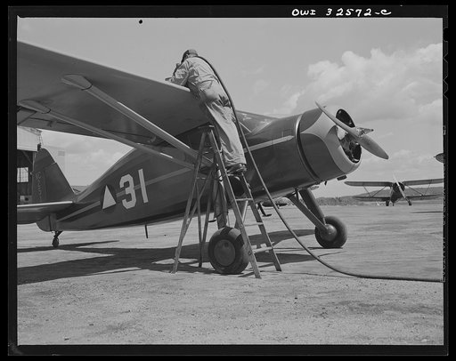 Untitled photo, possibly related to: Bar Harbor, Maine. Civil Air Patrol base headquarters of coastal patrol no. 20. Gassing a plane