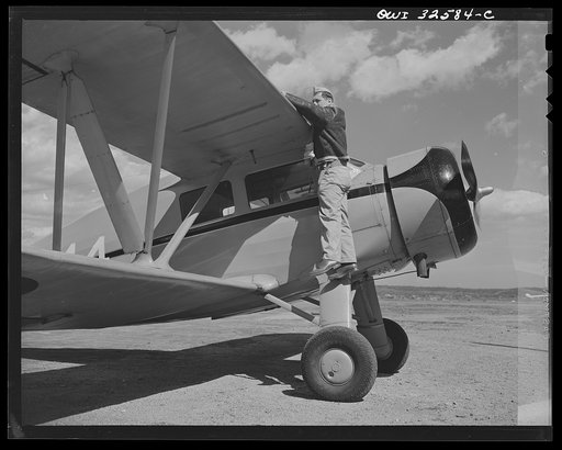 Untitled photo, possibly related to: Bar Harbor, Maine. Civil Air Patrol base headquarters of coastal patrol no. 20. Ground crew making a routine overhaul of a patrol plane