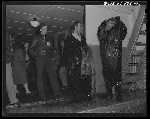 Bar Harbor, Maine. Civil Air Patrol base headquarters of coastal patrol no. 20. Flyers extracting themselves from all-rubber crash suits after a test in the swimming pool
