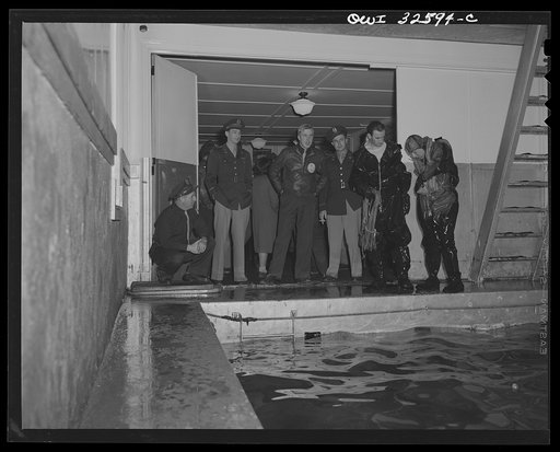 Bar Harbor, Maine. Civil Air Patrol base headquarters of coastal patrol no. 20. Flyers extracting themselves from all-rubber crash suits after a test in the swimming pool