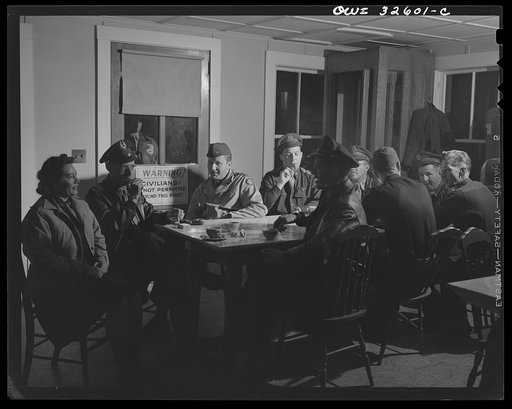 Bar Harbor, Maine. Civil Air Patrol base headquarters of coastal patrol no. 20. Personnel warming up in the canteen before the dawn patrol. The woman at the near end of the table works in the control tower