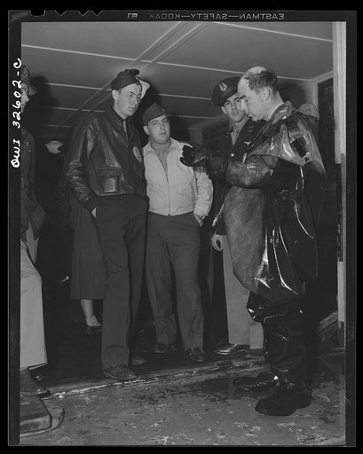 Untitled photo, possibly related to: Bar Harbor, Maine. Civil Air Patrol base headquarters of coastal patrol no. 20. Flyers extracting themselves from all-rubber crash suits after a test in the swimming pool
