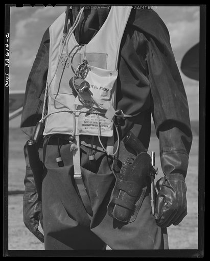 Bar Harbor, Maine. Civil Air Patrol base headquarters of coastal patrol no. 20. Flying equipment of a patrol flyer; rubber crash suit, "Mae West" life preserver, dye marker, flashlight with red lens, very pistol, revolver and sheath knife