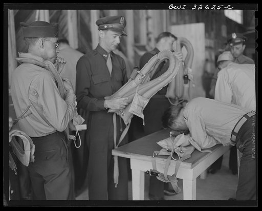 Untitled photo, possibly related to: Bar Harbor, Maine. Civil Air Patrol base headquarters of coastal patrol no. 20. Major J.B. King, base commander, inspecting "Mae West" life preservers