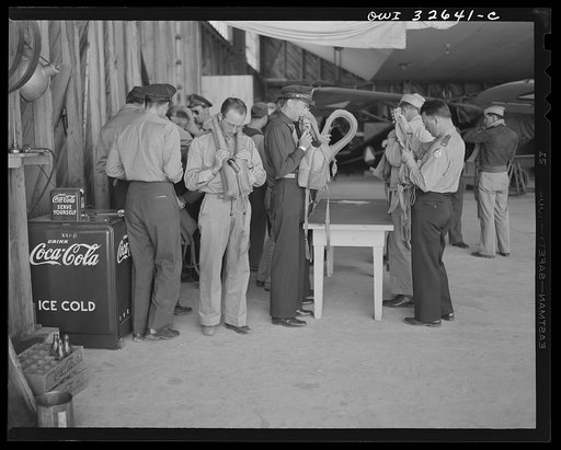 Bar Harbor, Maine. Civil Air Patrol base headquarters of coastal patrol no. 20. Routine inspection of "Mae Wests," life-preserving vests worn by flyers on all patrols over water