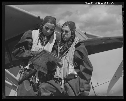 Untitled photo, possibly related to: Bar Harbor, Maine. Civil Air Patrol base headquarters of coastal patrol no. 20. A pilot and an observer dressed in rubber crash suits worn by fliers throughout the winter months