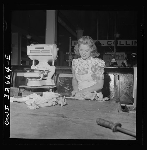 Washington, D.C. Betty Jane Colbert, a worker at the Arcade butcher shop, dismembering a chicken